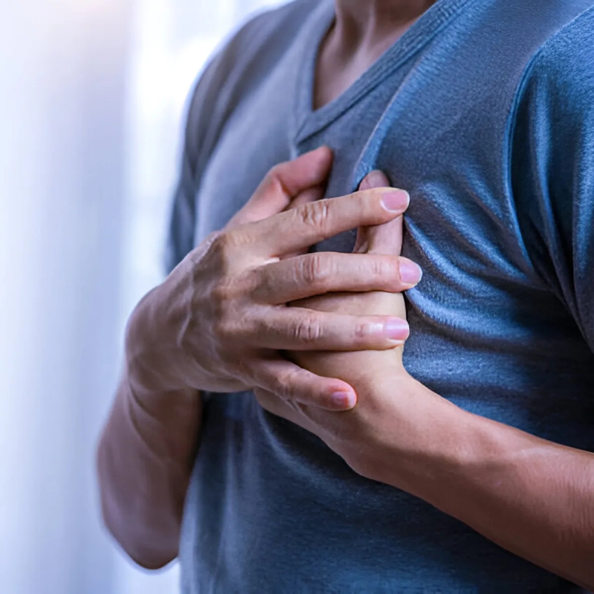 man experiencing chest pain man experiencing chest pain